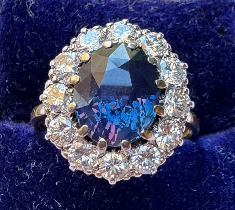 A 4.07 carat colour change Ceylon sapphire & diamond cluster ring turns from blue to purple under incandescent light