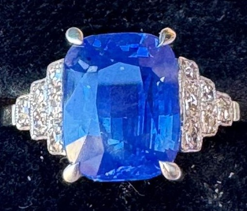 Art Deco 4.51 carat Sri-Lankan sapphire in platinum and 18ct white gold, has six small millegrain set diamonds to each shoulder and is estimated at £3,000-4,000