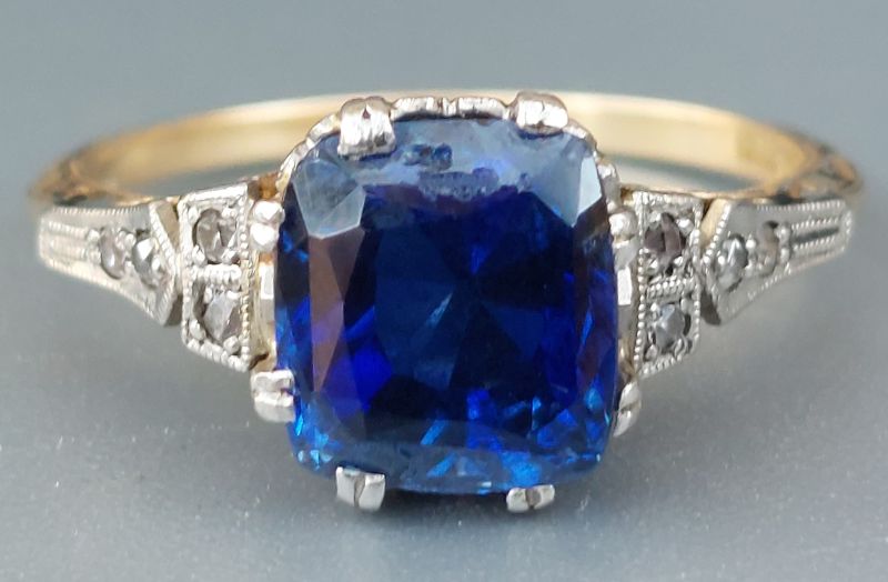 4.78 carat example is a cushion cut stone with small diamonds to shoulders